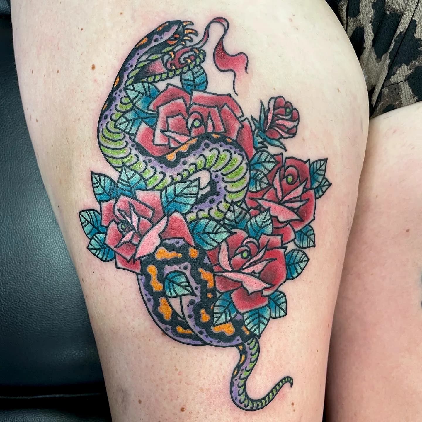 Snake and roses traditional colour tattoo by Nate at Village Tattoo Company London Ontario